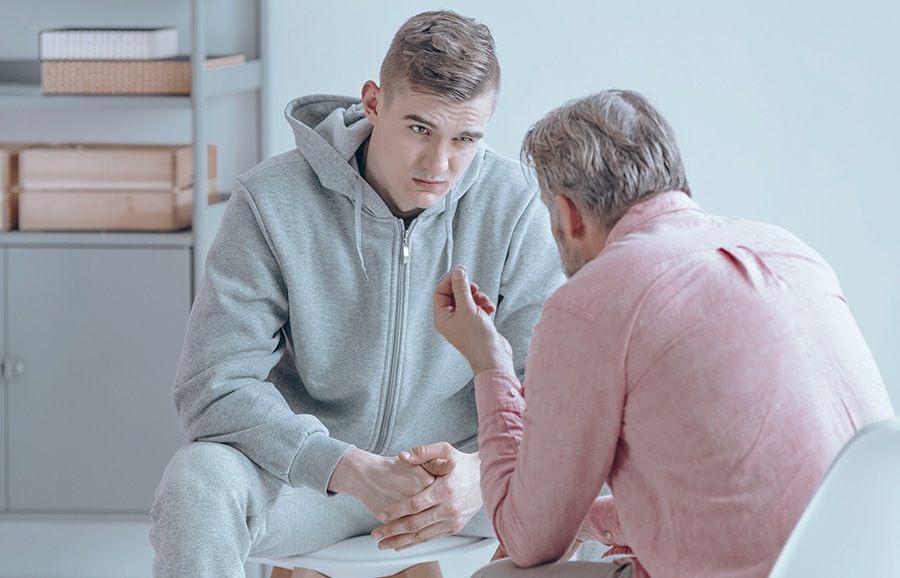 stock image of a son talking to his father about addiction recovery services in Huntington Beach